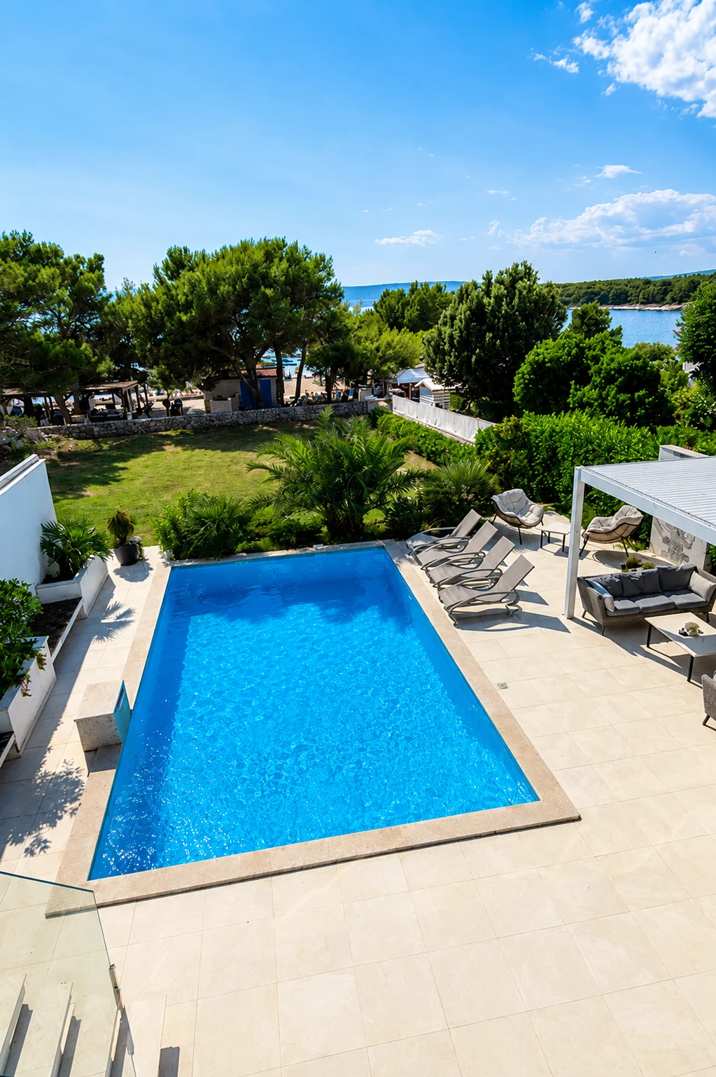 Aerial view of the pool, bay and beach at Punat