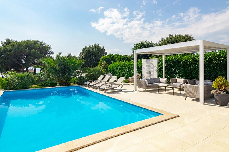 Poolside lounge and pergola at Villa Azure Oasis